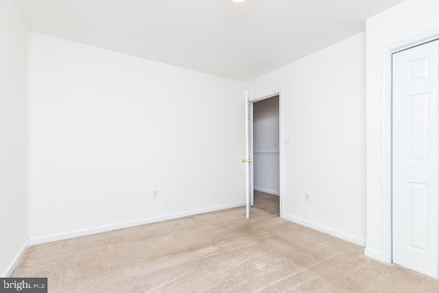 unfurnished bedroom with light colored carpet