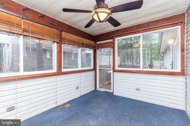 unfurnished sunroom featuring ceiling fan