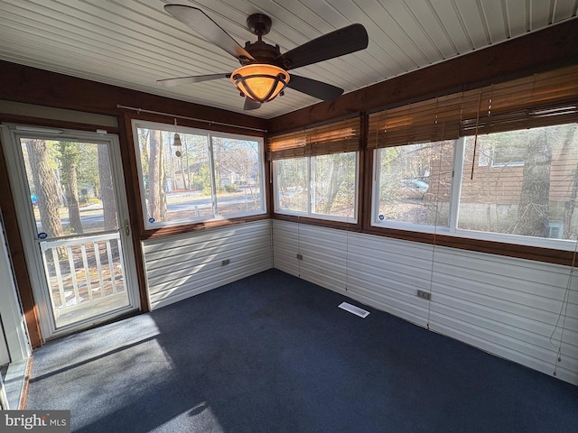 unfurnished sunroom featuring ceiling fan