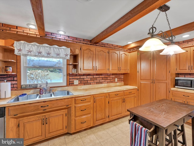 kitchen featuring wooden counters, sink, appliances with stainless steel finishes, beamed ceiling, and decorative light fixtures