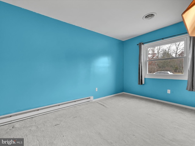 carpeted spare room with a baseboard radiator