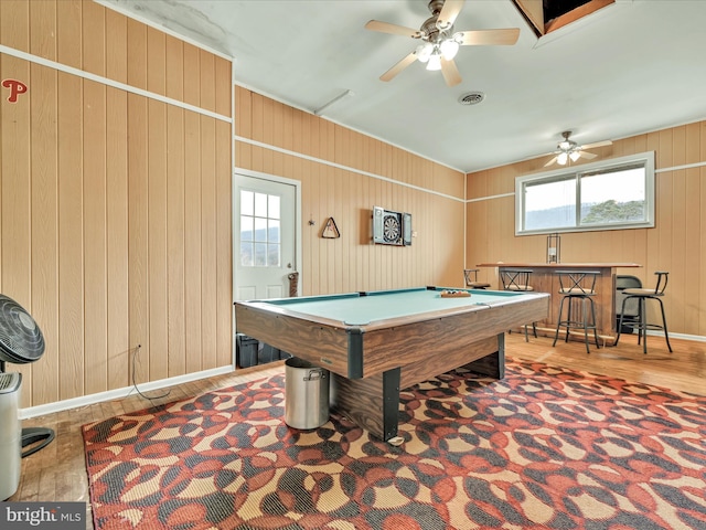 recreation room featuring ceiling fan, wooden walls, indoor bar, hardwood / wood-style flooring, and pool table