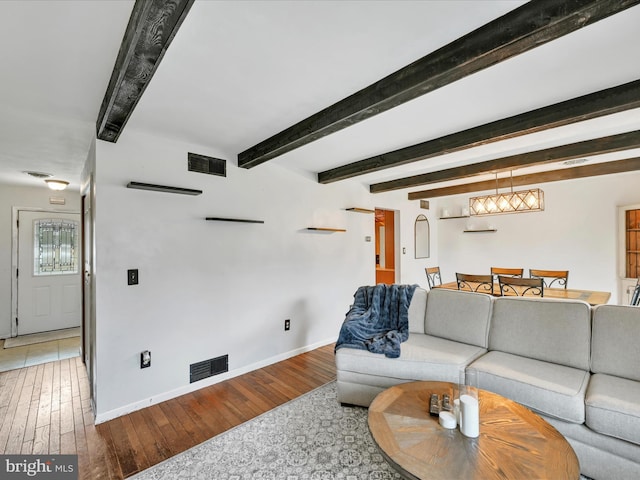 living room with hardwood / wood-style floors and beamed ceiling