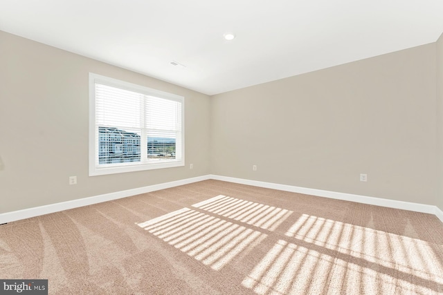 unfurnished room featuring carpet