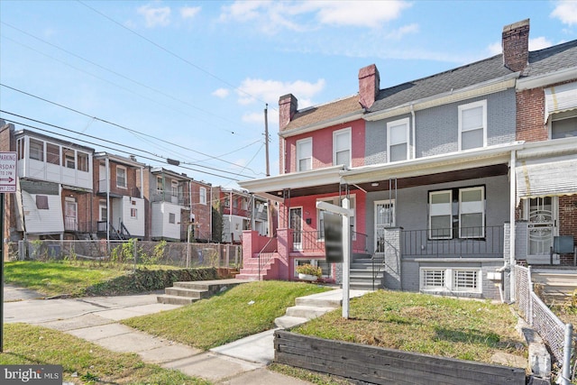 townhome / multi-family property featuring covered porch