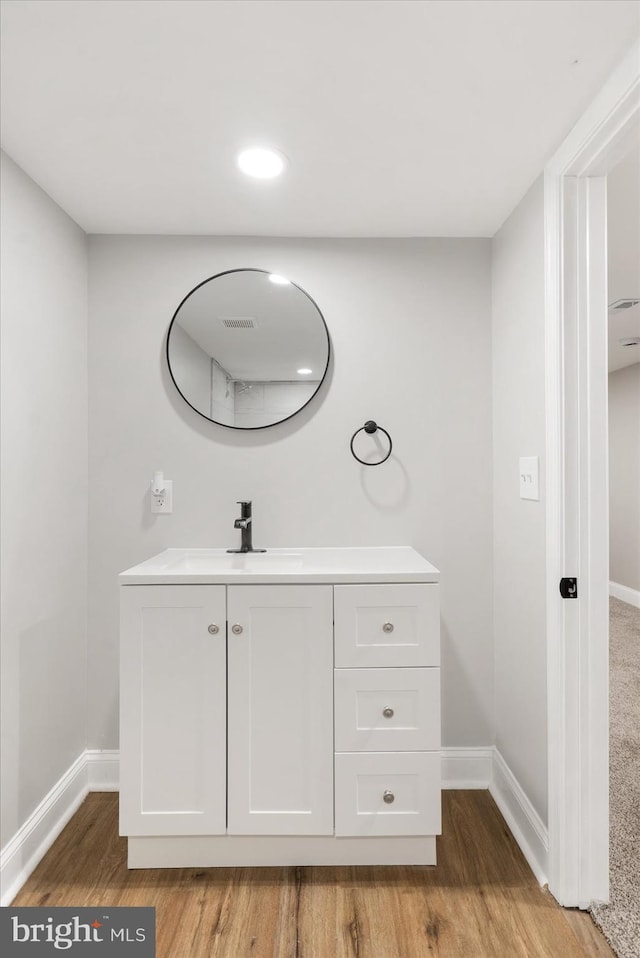 bathroom with hardwood / wood-style floors and vanity