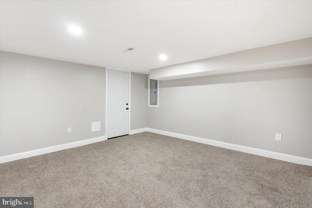 basement with carpet flooring and electric panel