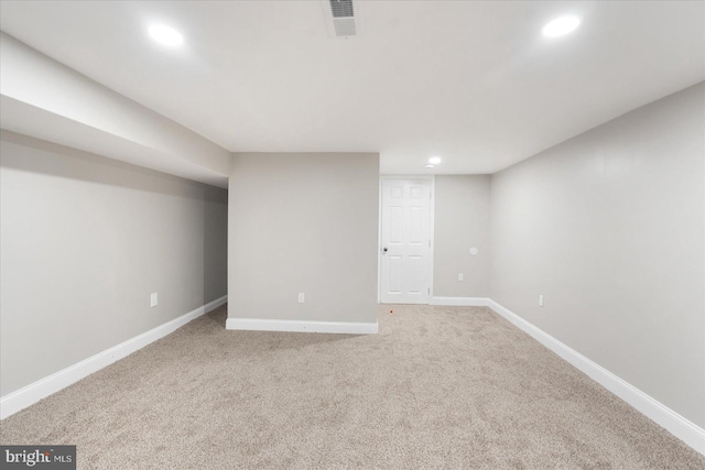 basement featuring light colored carpet