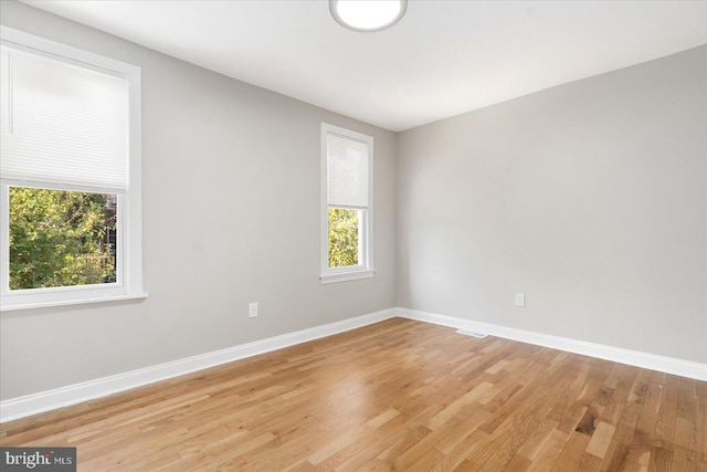 spare room with light hardwood / wood-style flooring