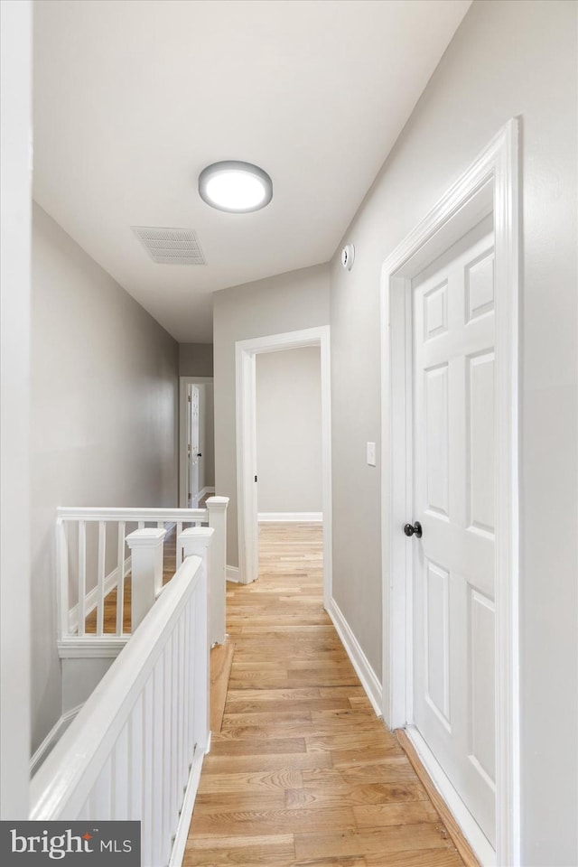 hallway with light hardwood / wood-style flooring