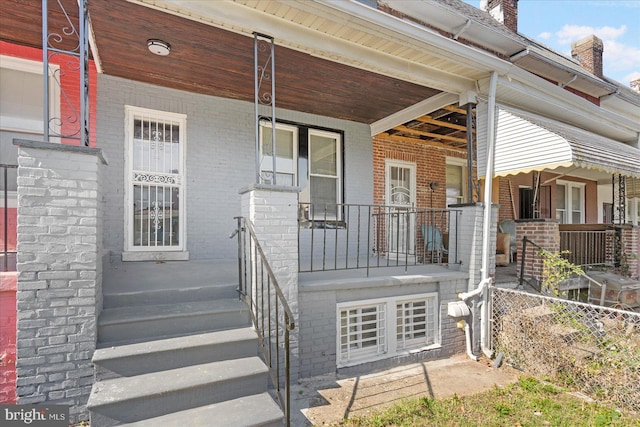 property entrance with covered porch