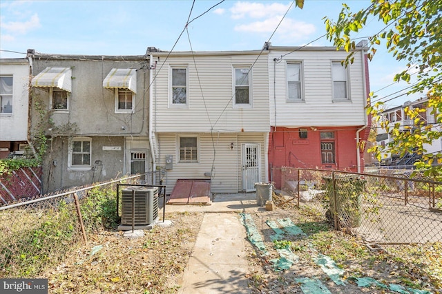 rear view of property featuring central AC