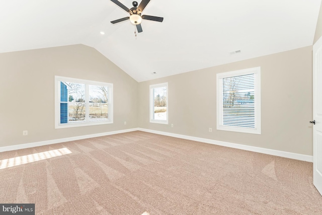 unfurnished room with light carpet, vaulted ceiling, and ceiling fan