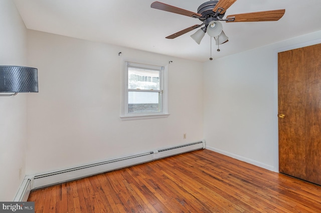 spare room with baseboard heating, light hardwood / wood-style flooring, and ceiling fan