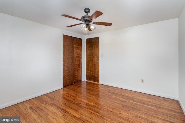 empty room with ceiling fan and hardwood / wood-style floors