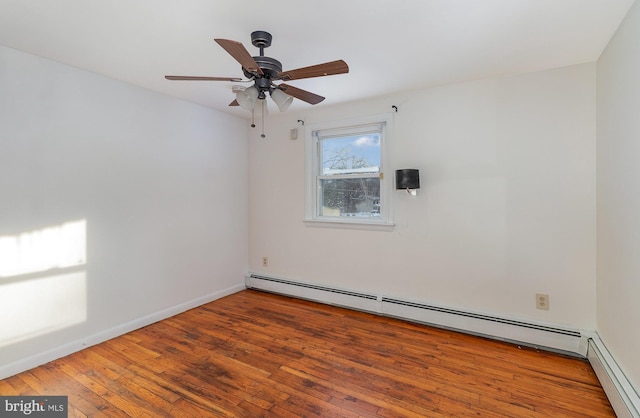 empty room featuring a baseboard heating unit, ceiling fan, and hardwood / wood-style floors