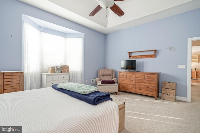 bedroom with light carpet, ceiling fan, and baseboards