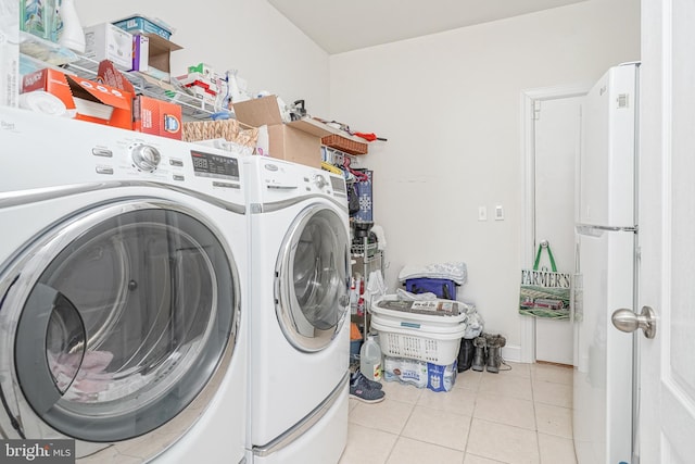 laundry area featuring laundry area, separate washer and dryer, and light tile patterned floors