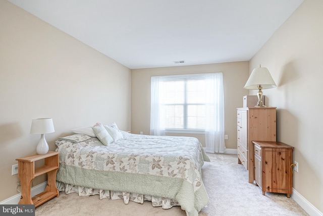 bedroom featuring light carpet, visible vents, and baseboards