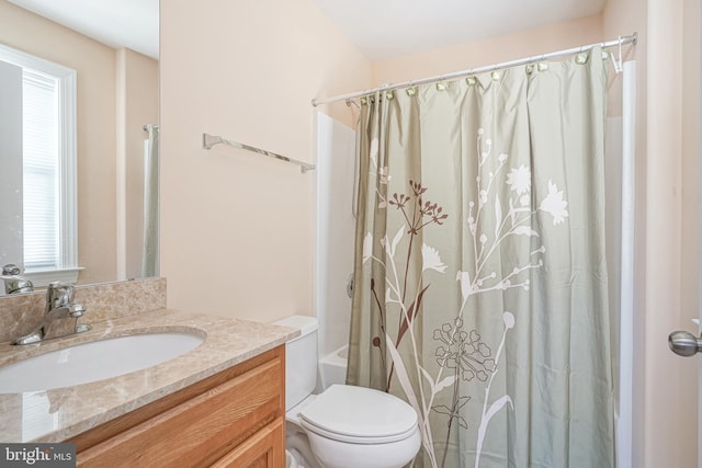 bathroom featuring shower / tub combo, vanity, and toilet