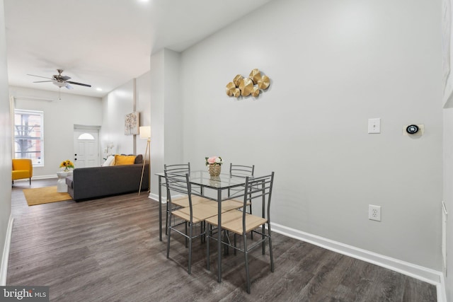 dining space with dark hardwood / wood-style floors and ceiling fan