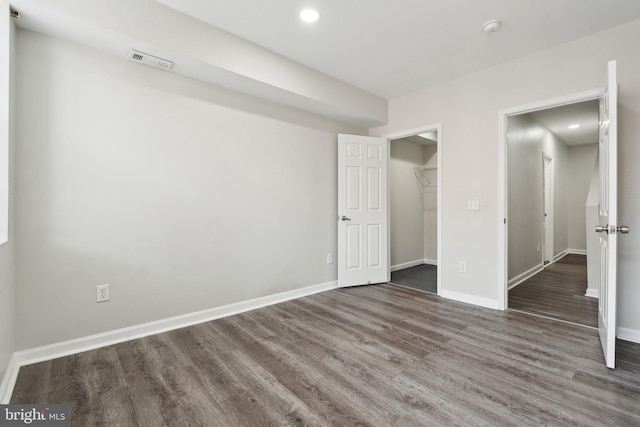 unfurnished bedroom with dark hardwood / wood-style floors