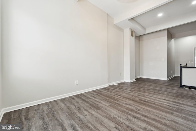 basement with dark hardwood / wood-style flooring