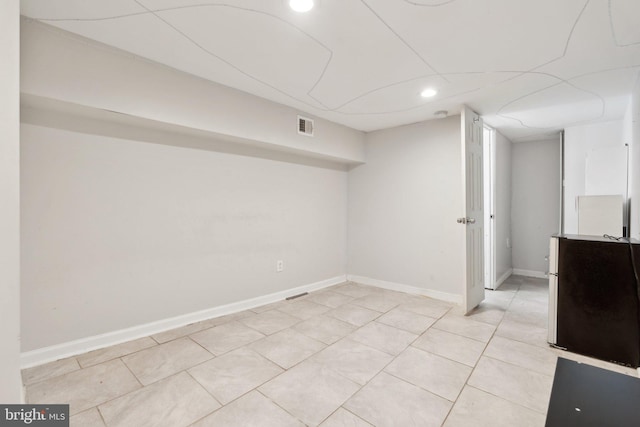 basement featuring light tile patterned floors