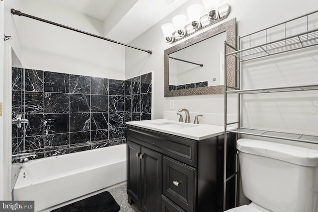 full bathroom with tiled shower / bath combo, toilet, and vanity