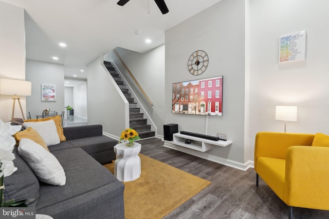 living room featuring dark hardwood / wood-style flooring and ceiling fan