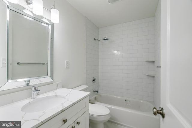 full bathroom with vanity, toilet, and tiled shower / bath