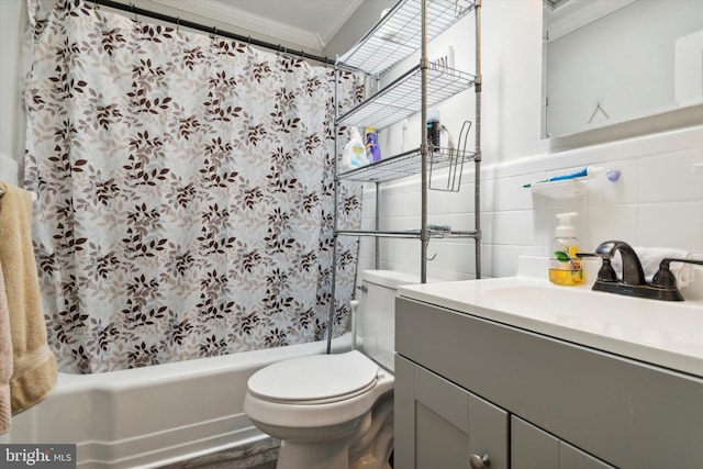 full bathroom with vanity, shower / tub combo with curtain, crown molding, tile walls, and toilet