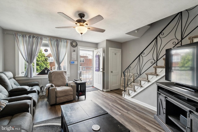 living room featuring dark hardwood / wood-style floors and ceiling fan