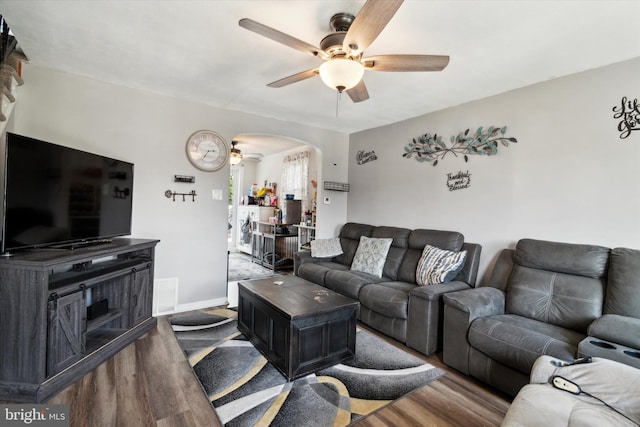 living room featuring hardwood / wood-style floors and ceiling fan