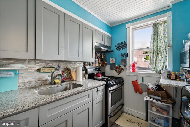 kitchen featuring light stone countertops, sink, backsplash, crown molding, and stainless steel range with gas stovetop