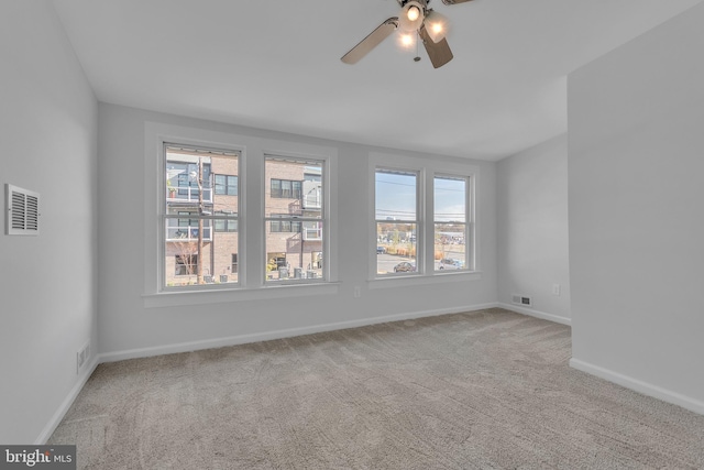 empty room featuring carpet and ceiling fan