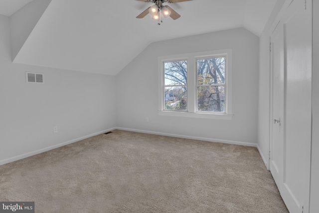 bonus room with ceiling fan, light colored carpet, and vaulted ceiling