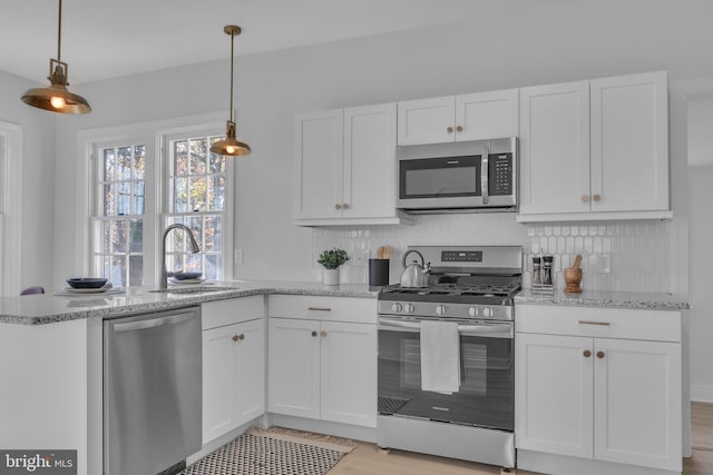 kitchen with white cabinets, sink, and stainless steel appliances