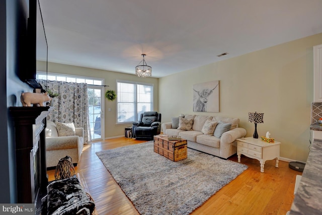 living room featuring hardwood / wood-style floors and a notable chandelier