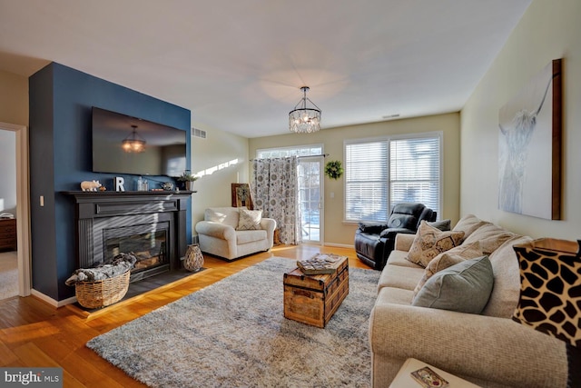 living room featuring hardwood / wood-style floors and a notable chandelier