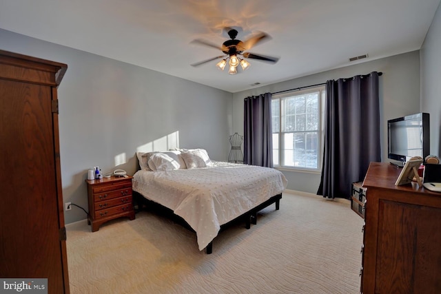 bedroom with ceiling fan and light colored carpet