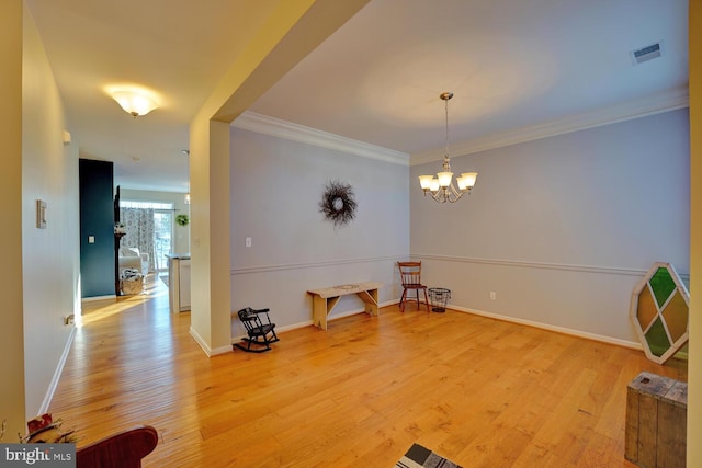 interior space featuring a chandelier, ornamental molding, and light wood-type flooring