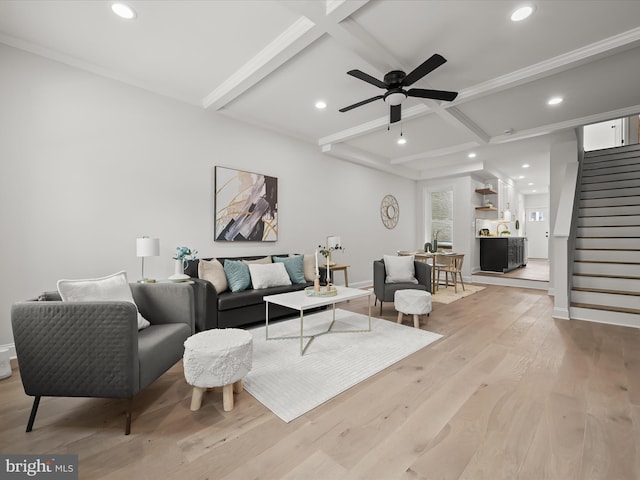 living room with beam ceiling, ceiling fan, coffered ceiling, and light hardwood / wood-style flooring