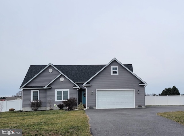 view of front of property featuring a front yard and a garage