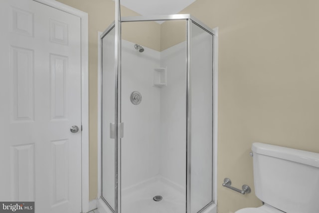 bathroom with walk in shower and toilet