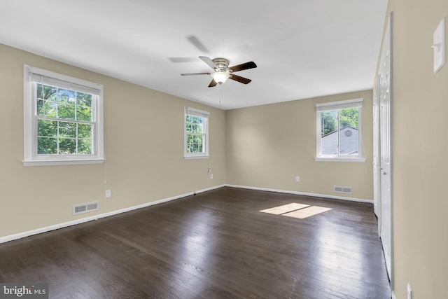 spare room with dark hardwood / wood-style floors and ceiling fan