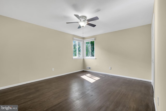 unfurnished room with ceiling fan and dark hardwood / wood-style floors