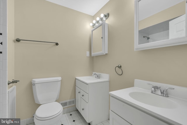 bathroom with tile patterned flooring, vanity, and toilet