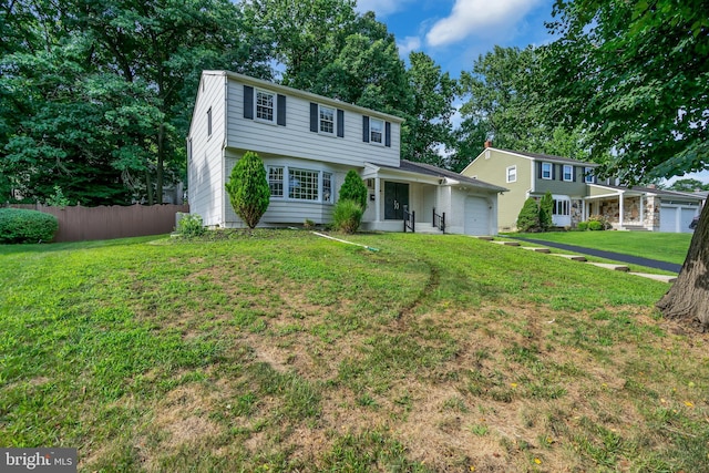 view of front of house featuring a front yard and a garage