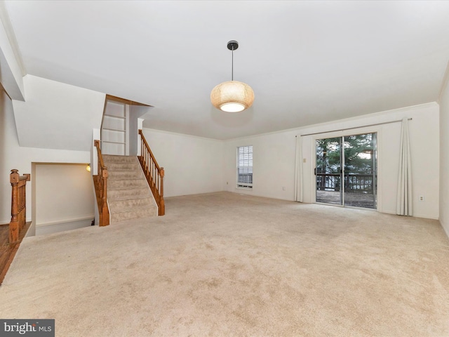 unfurnished living room with carpet floors and ornamental molding